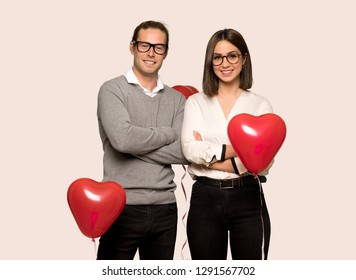 Couple in valentine day with glasses and happy over isolated background