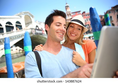 Couple in Venice standing in front of the Rialto bridge