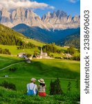Couple viewing the landscape Italy dolomites Val di Funes in summer, Santa Magdalena village magical Dolomites mountains, Val di Funes valley, Trentino Alto Adige region, South Tyrol, Italy,