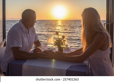 Couple viewing subset in sea restaurant 