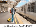 couple waiting for train on railway station platform. Meeting, saying goodbye spouse, friends. Travel lifestyle concept