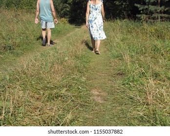 A Couple Walking Apart In A Park, Concept Of Relationships, Outdoor Cropped Image