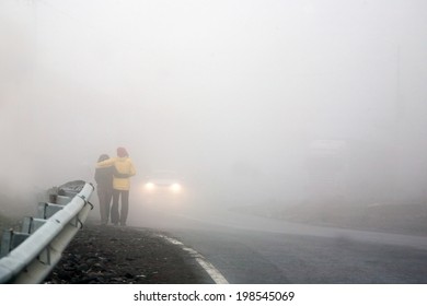 Couple Walking Away Into The Fog