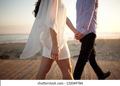 Couple Walking Away On Beach