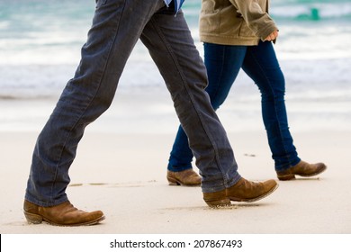 Couple Walking Away On The Beach