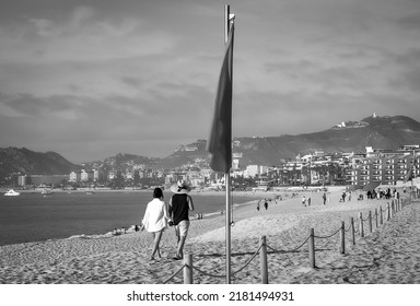 Couple Walking At The Beach In Los Cabos, Mexico In Black And White