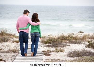 Couple walking by the sea