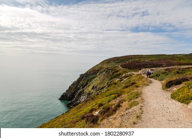 Couple walking at the cliffs of Howth in Ireland - Powered by Shutterstock