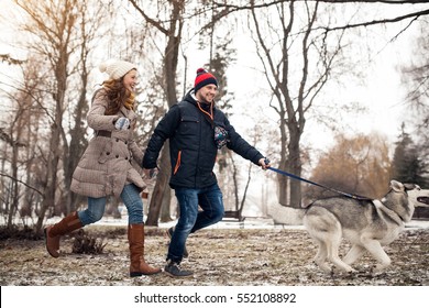 couple walking dog winter
