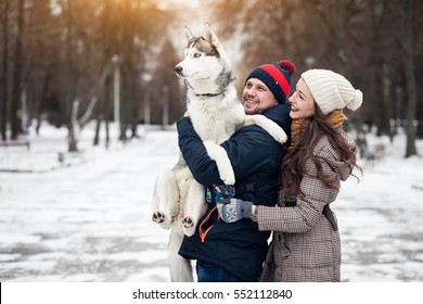 couple walking dog winter