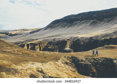 Couple Walking At Fjadrargljufur Canyon In Iceland.
