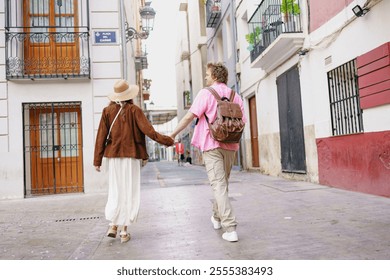 Couple Walking Hand in Hand Through a Charming and Picturesque City Alleyway Filled with Life - Powered by Shutterstock