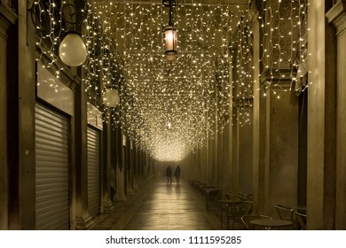 Couple walking at night under Christmas Lights in Venice, Italy, in a winter day of December - Shutterstock ID 1111595285
