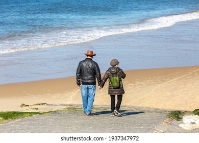couple walking on the beach hand in hand