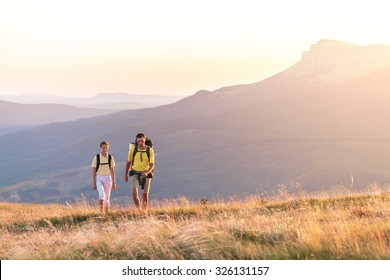 Couple Walking On Hill And Field In The Summer