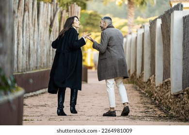 A couple walking on a path and arguing - Powered by Shutterstock