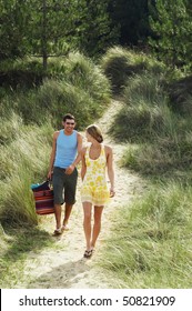 Couple Walking On Trail To Beach, High Angle View