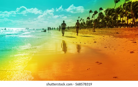 A Couple Walking At The Resort Tropical Beach In Punta Cana, Dominican Republic