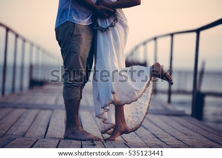 Couple walking seaside, love story concept near sea, walking and holding each others hands, 
