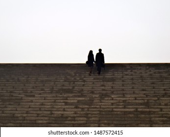 A Couple Walking Up Stairs Spotted In Seoul, South Korea