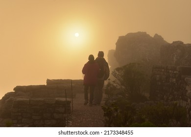 A Couple Walking At Sunset On Table Mountain