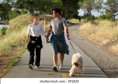 Couple walking their dog