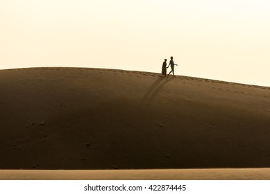 Couple Walking Together In Desert