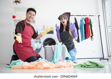 Couple Washing Clothes In The Laundry Room