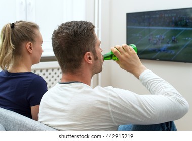 Couple Watching American Football On Tv.