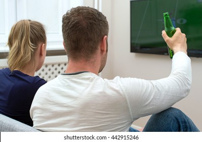 Couple Watching American Football On Tv.