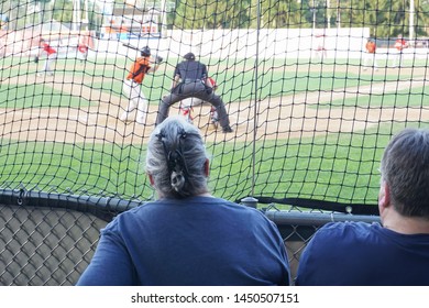 A Couple Watching A Baseball Game.