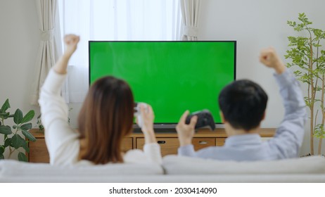 A Couple Watching Chroma Key TV