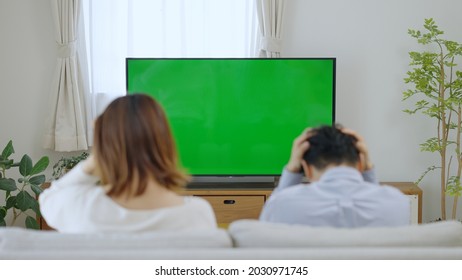 A Couple Watching Chroma Key TV