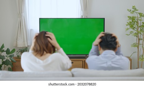 A Couple Watching Chroma Key TV