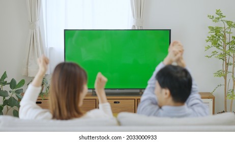 A Couple Watching Chroma Key TV