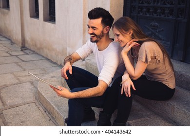 Couple Watching Digital Touchscreen Tablet Ipad And Laughing In The Street