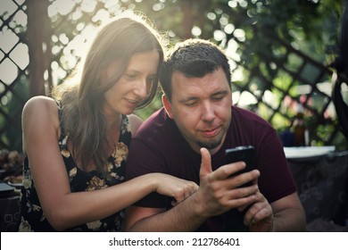 Couple Watching Film On Smart Phone