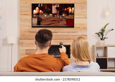 Couple Watching Romantic Movie On TV In Living Room