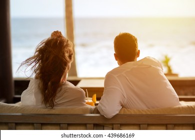 
Couple Watching The Sea From The Terrace Of  Their Apartment, Enjoying In Beautiful View 