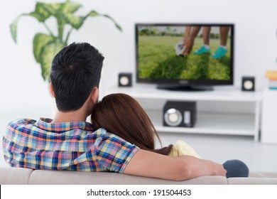 Couple Watching Soccer Game On Tv, View From The Back