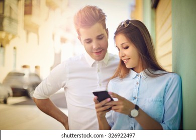 Couple Watching Something On A Smart Phone