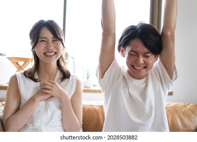 A Couple Watching A Sports Game At Home