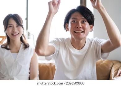 A Couple Watching A Sports Game At Home