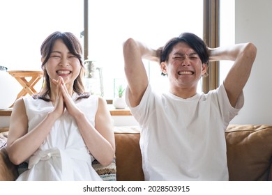 A Couple Watching A Sports Game At Home