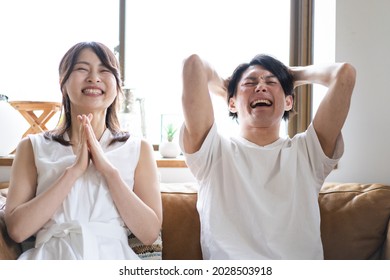 A Couple Watching A Sports Game At Home