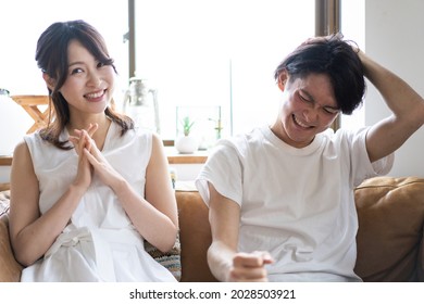 A Couple Watching A Sports Game At Home