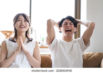 A Couple Watching A Sports Game At Home