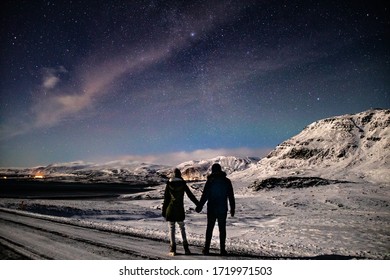 Couple Watching Stars At Winter Night