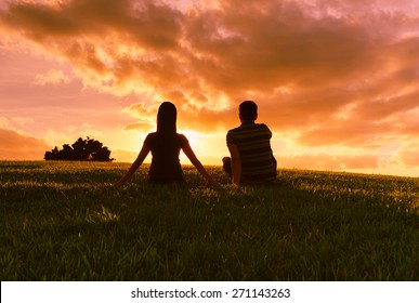 Couple Watching The Sunset. 