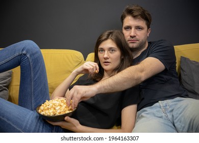 Couple Watching Tv Movie Hugging Lying On Couch With Popcorn. Girlfriend And Boyfriend Watch Love Story, Investigation, Thriller On YouTube Channel Online Broadcast. Evening Entertainment Young Family